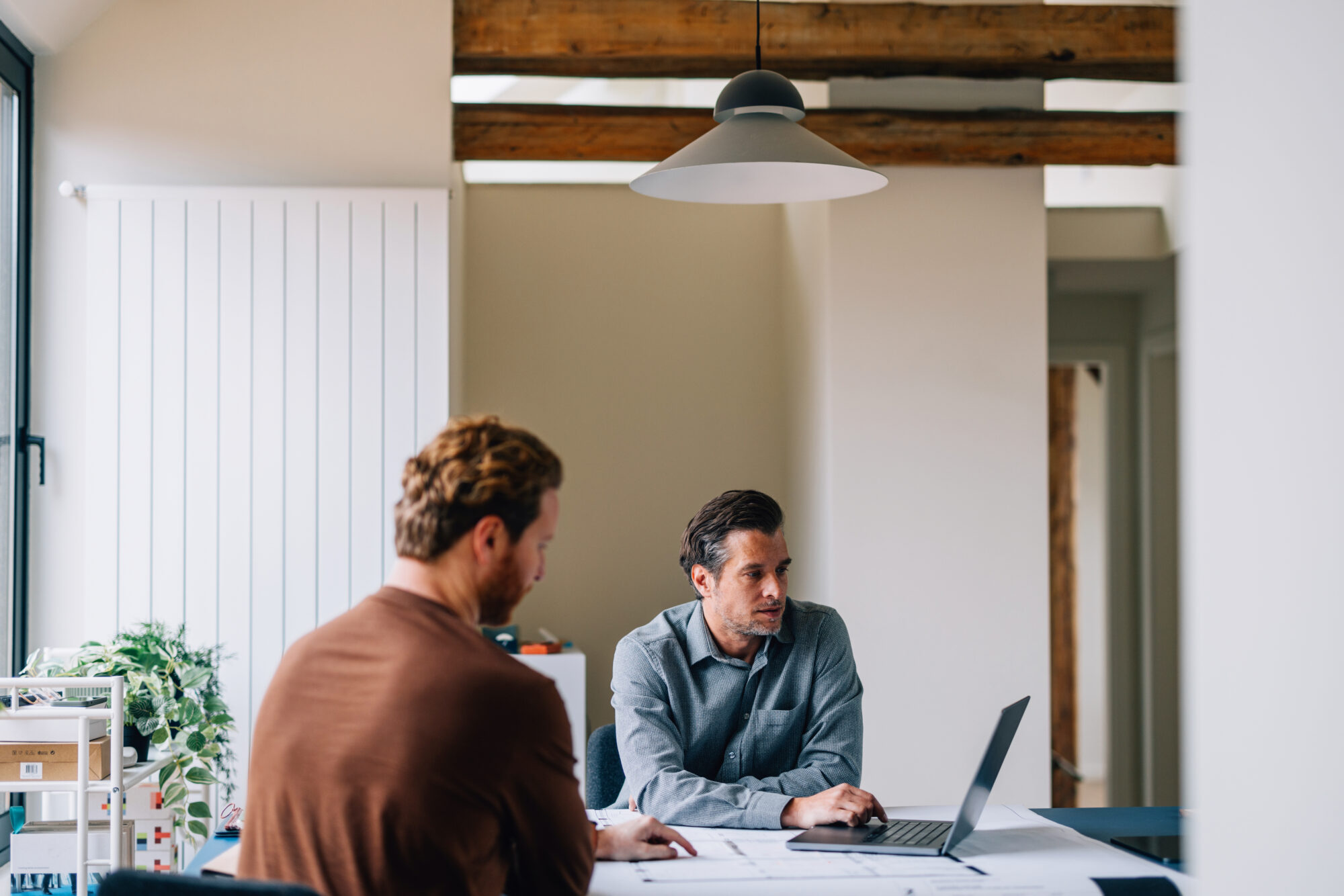 Two Professionals Engaged in a Business Discussion at a Modern Office