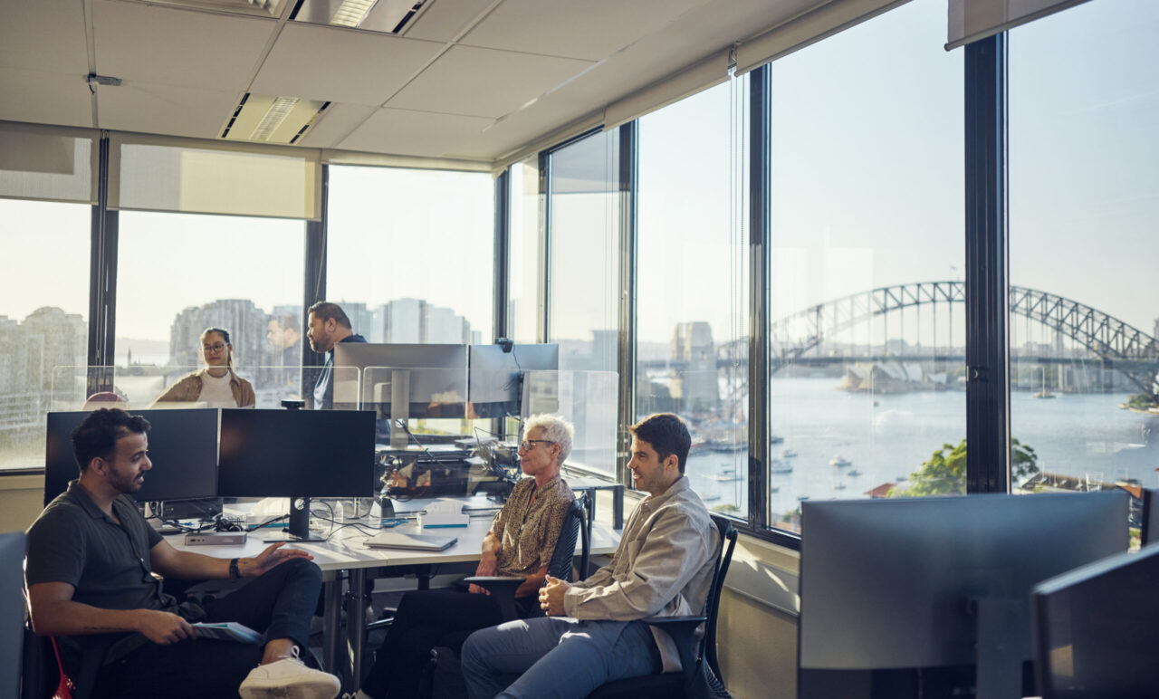 Colleagues from diverse backgrounds working together harmoniously in an Australian office.