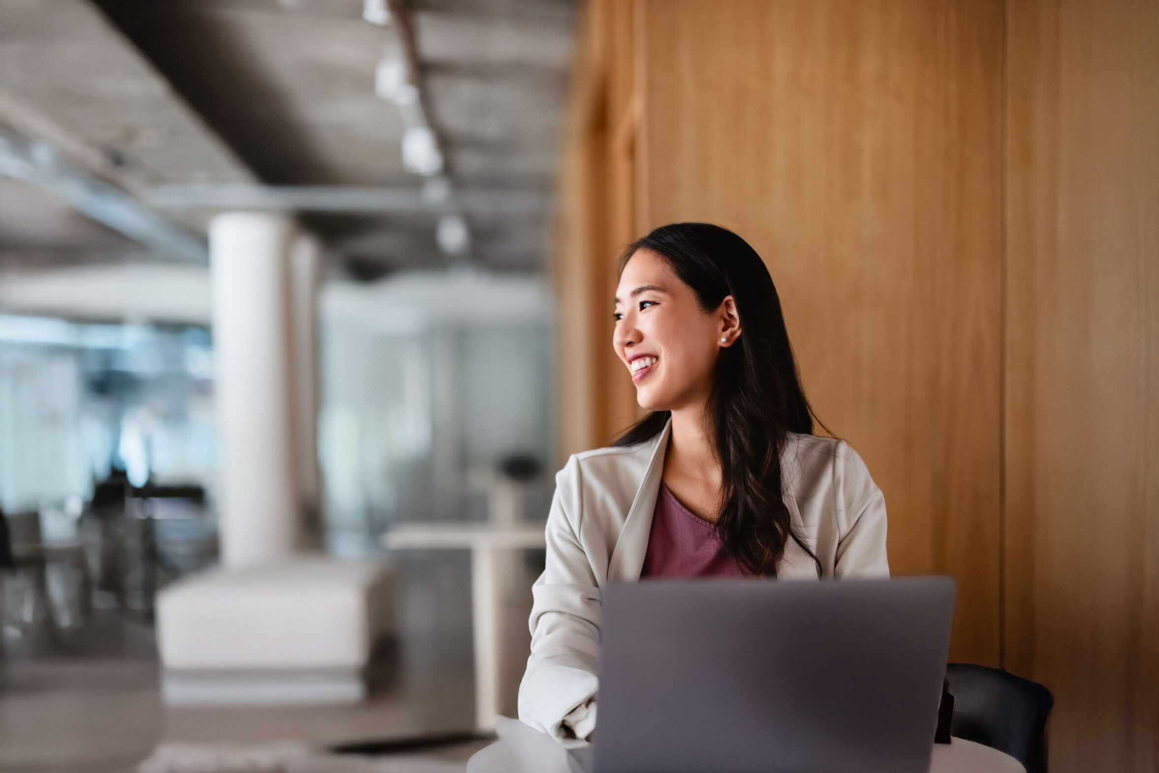 Prof female with laptop looking to the side